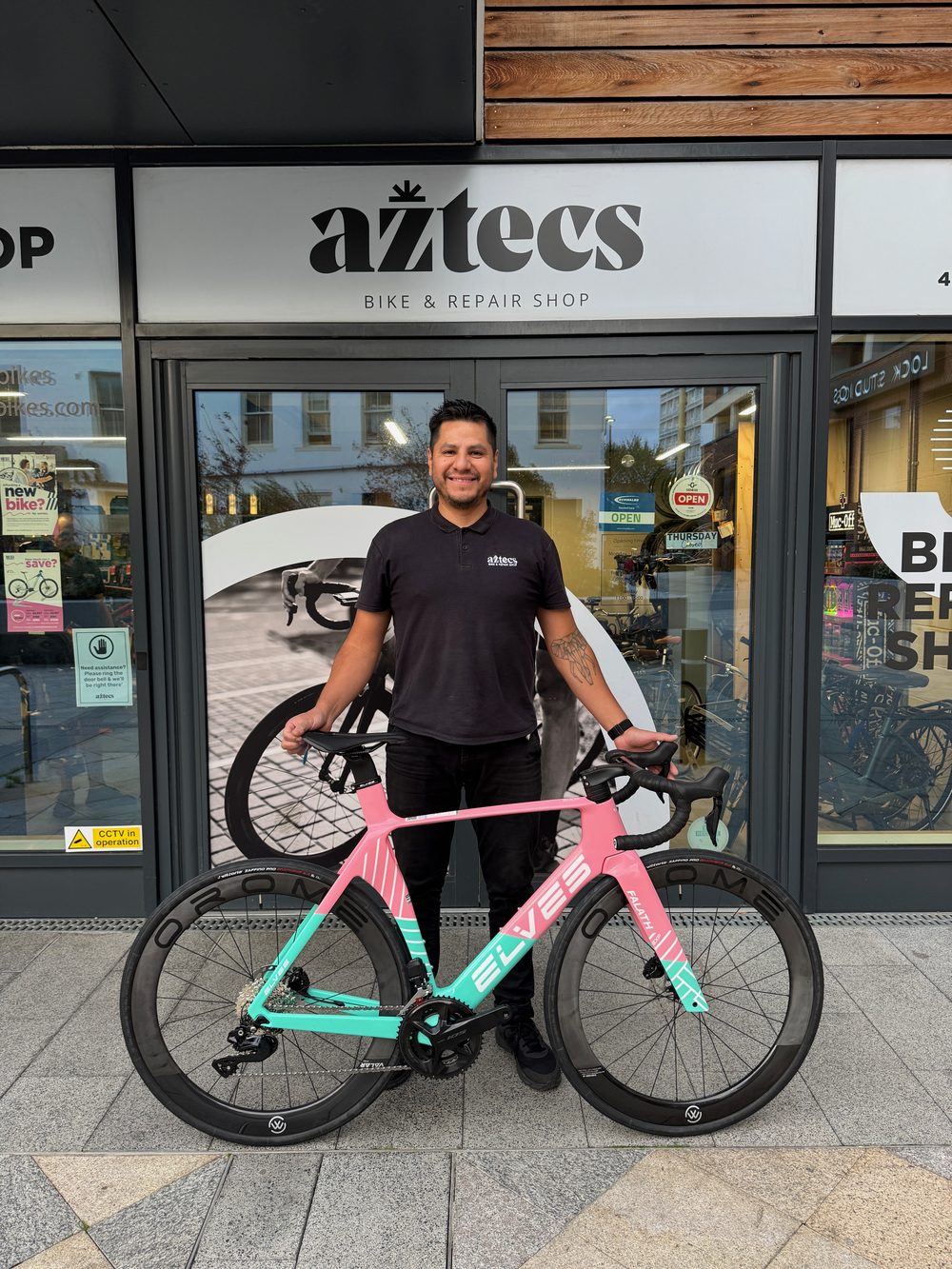 Marco outside the shop with a custom Elves road bike