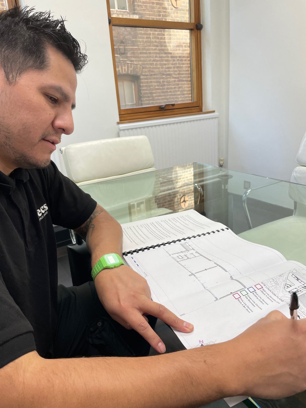 Marco reviewing the plans for the future shop